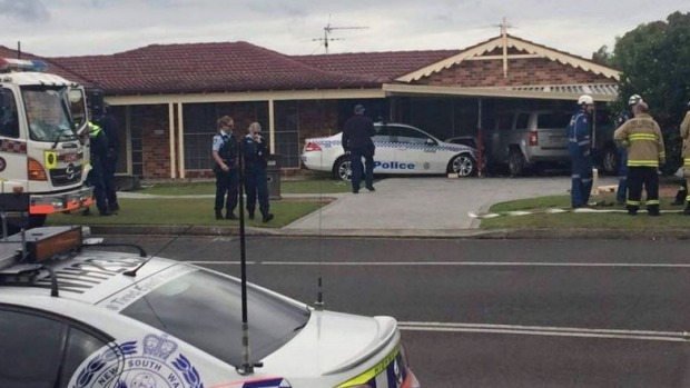 House, parked cars hit by police car allegedly driven by handcuffed man