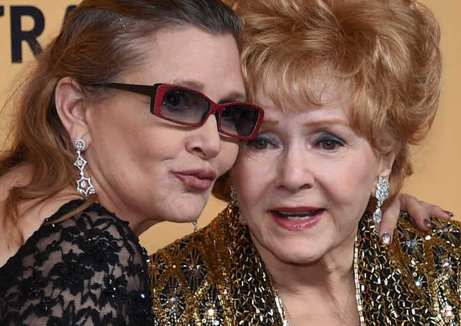Actress Debbie Reynolds dies of stroke, day after daughter Carrie Fisher