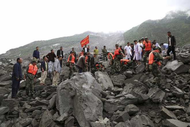 Over 100 people feared buried in China landslide