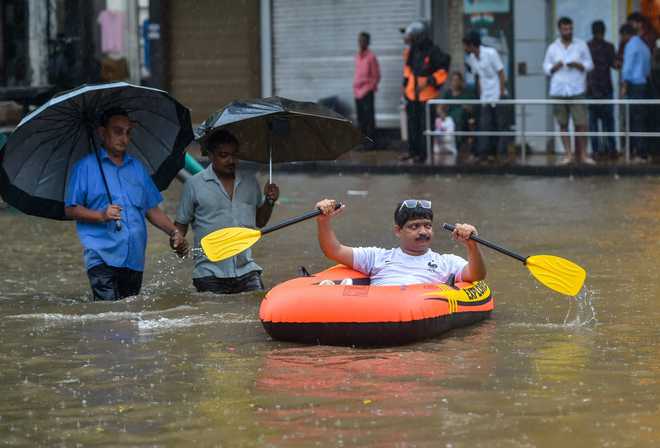 Boats on Mumbai roads as heavy rains kill 2